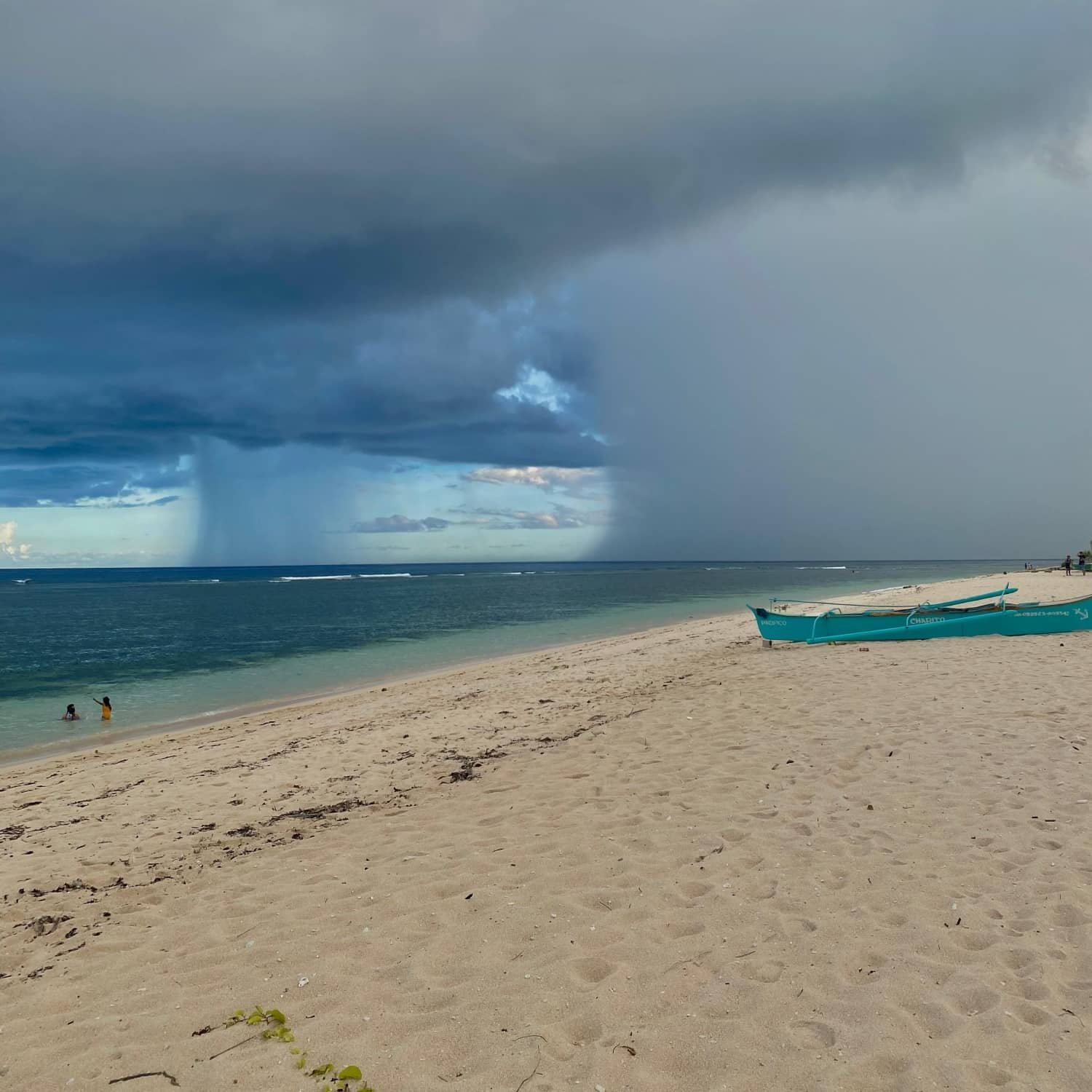 a view for the rain clouds coming over pacifico beach in siargao philippines