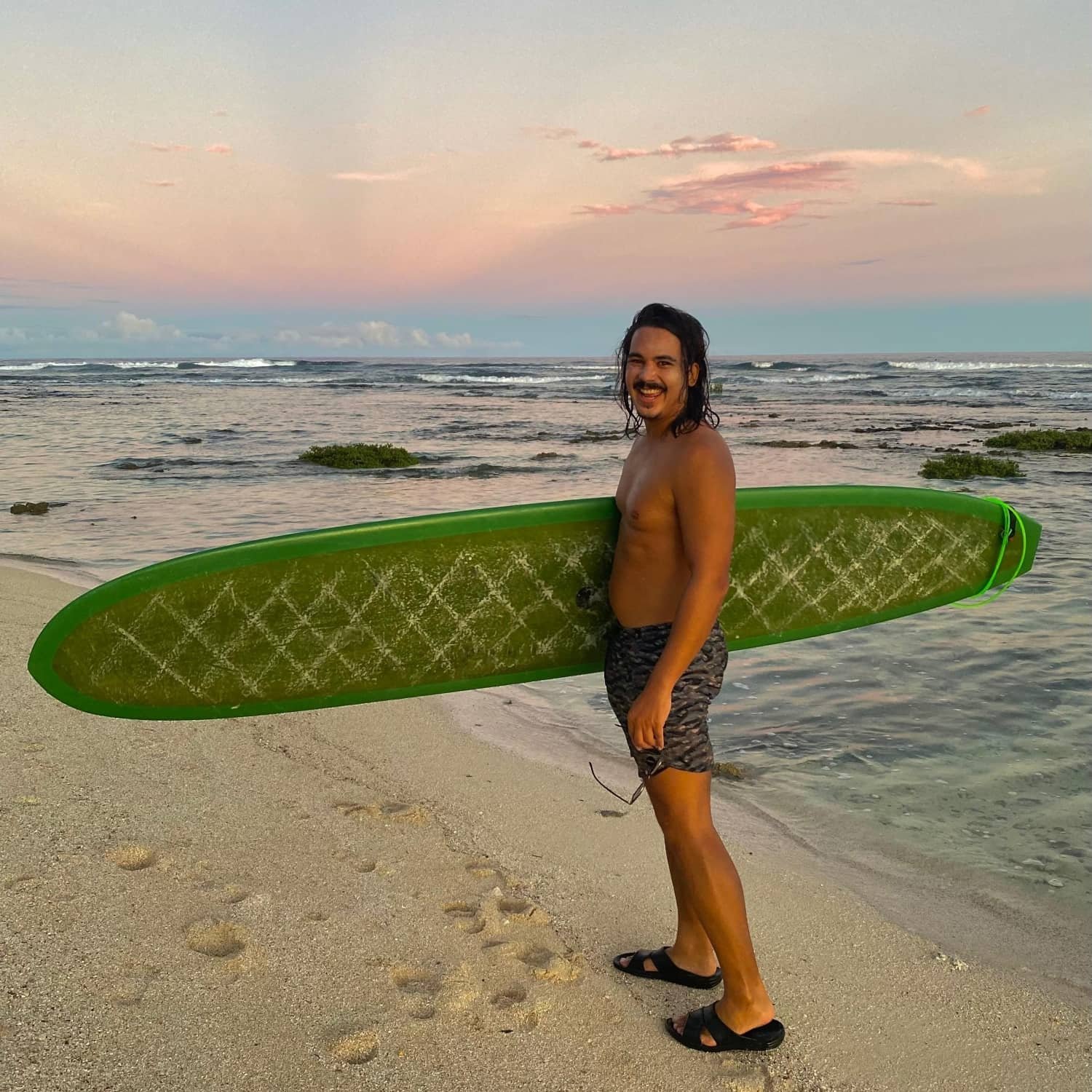 jamie after a surf at sunset at tauson point, siargao